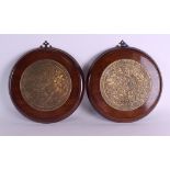 A PAIR OF 19TH CENTURY INDIAN PERSIAN BRASS AND MAHOGANY WALL PLAQUES Khorosan, engraved with