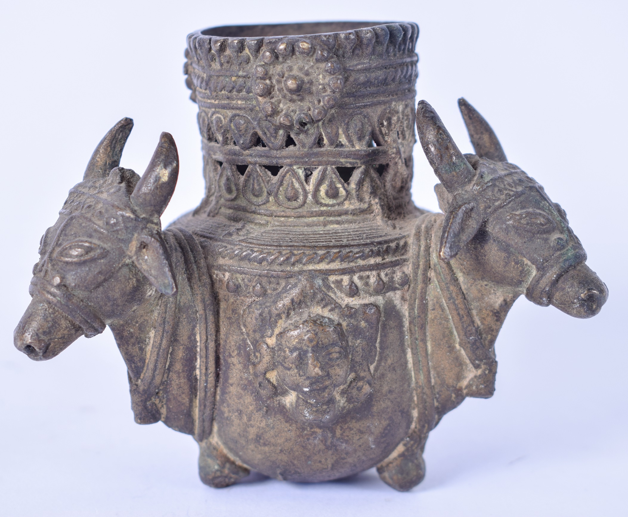 AN 18TH/19TH CENTURY INDIAN BRONZE CENSER, formed with three mask head handles. 9 cm high.