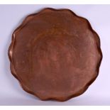 A LARGE ARTS AND CRAFTS COPPER CHARGER in the manner of Benson, decorated with swirling motifs. 59