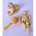 AN EARLY 20TH CENTURY RETICULATED IVORY FIGURE, together with an ivory lion and another. Largest 6.5