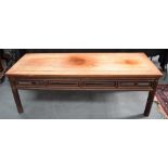 AN EARLY 20TH CENTURY CHINESE CARVED LOW HARDWOOD TABLE of plain form. 50 cm x 140 cm.