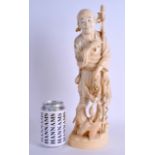 A LARGE 19TH CENTURY JAPANESE MEIJI PERIOD CARVED IVORY OKIMONO modelled as a fisherman standing