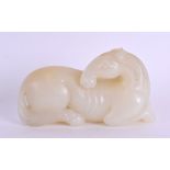 A GOOD 19TH CENTURY CHINESE CARVED JADE FIGURE OF A STYLISED HORSE Qing, modelled recumbent with its