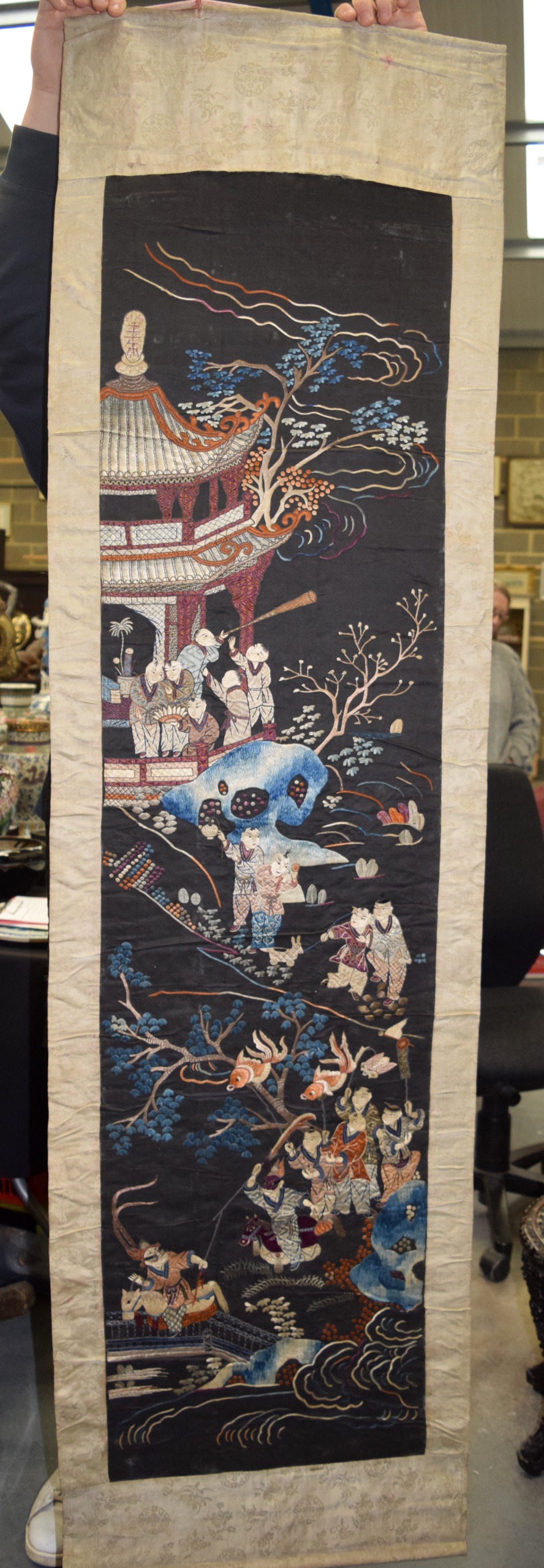 A GOOD 19TH CENTURY CHINESE SILKWORK HANGING SCROLL Qing, decorated with figures within landscapes