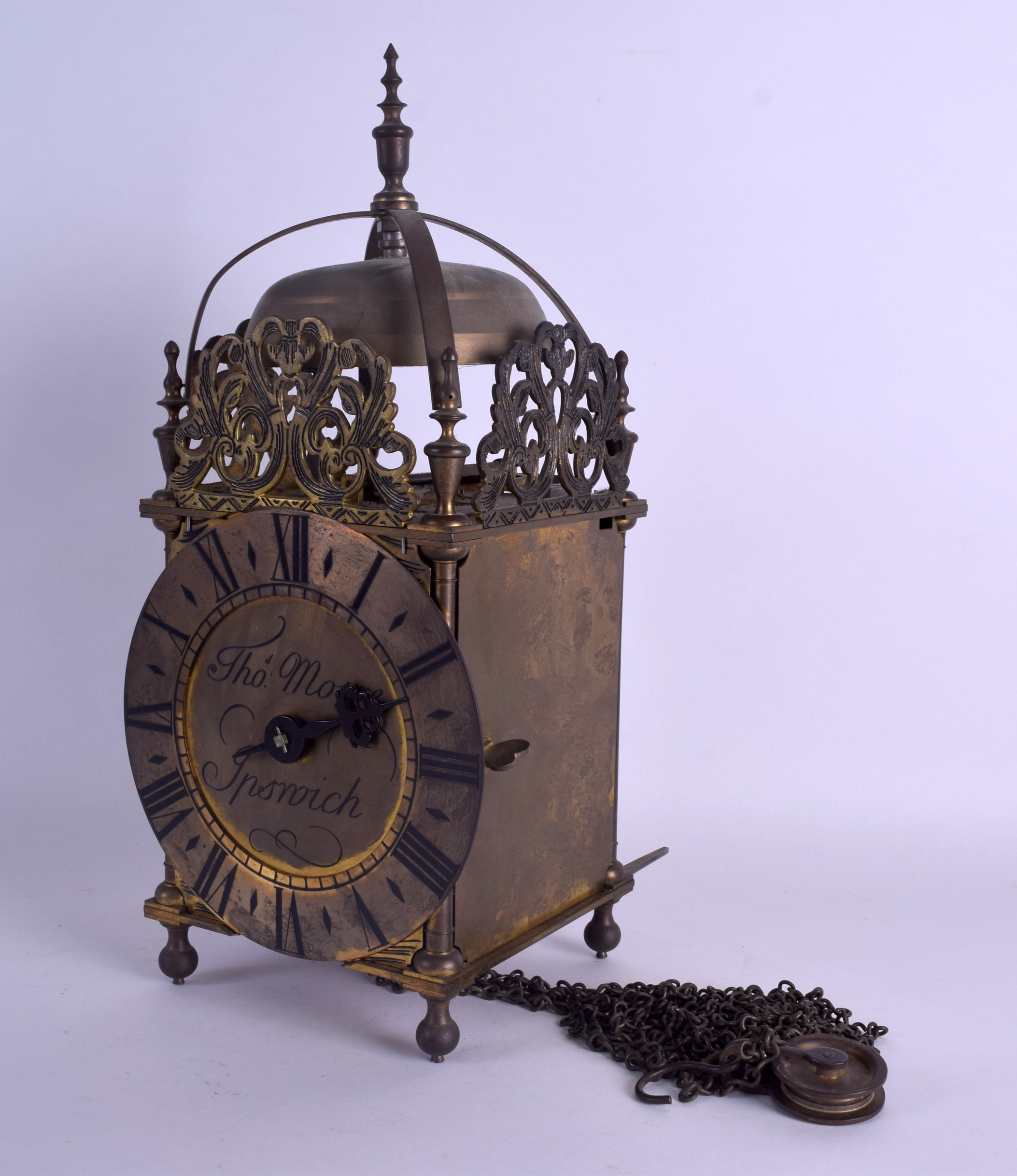 A BRASS LANTERN CLOCK by Thomas Moore of Ipswich, decorated with open work foliage. 37 cm x 15 cm.