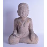 AN EARLY SOUTH EAST ASIAN CAMBODIAN CARVED STONE BUDDHA modelled as a seated female with gold
