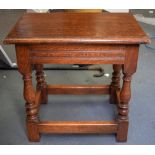 AN EARLY 20TH CENTURY OAK STOOL, with turned legs on four supporting stretchers. 46 cm x 45 cm.