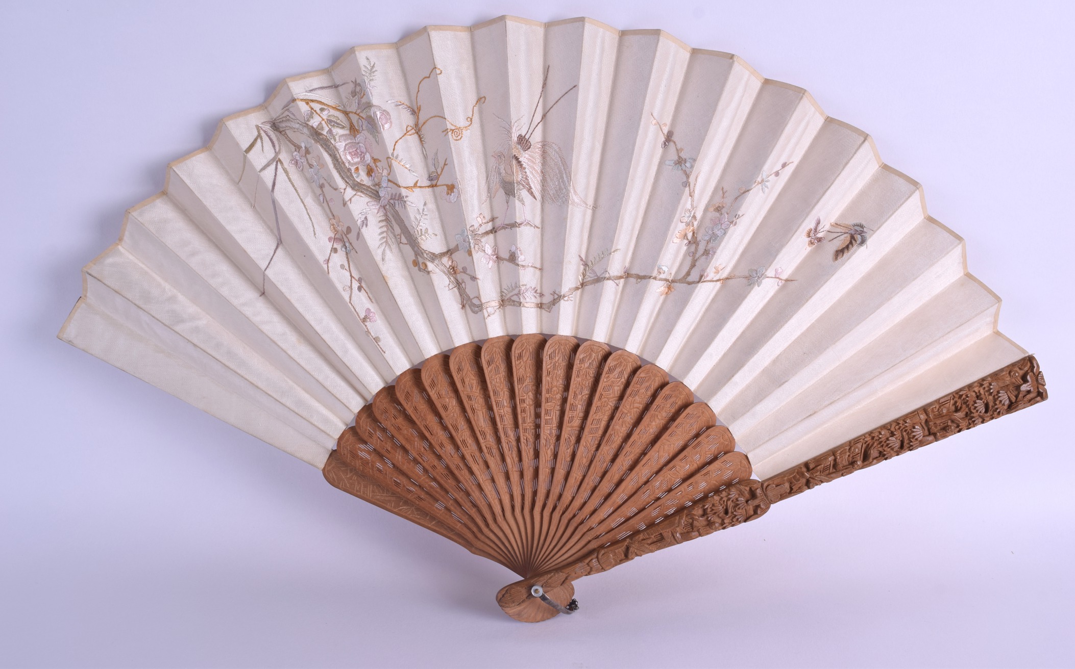 A 19TH CENTURY CHINESE CARVED SANDALWOOD AND SILK FAN Qing, decorated with butterflies amongst