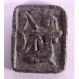 AN EGYPTIAN CARVED STONE TABLET possibly early, modelled with a figure holding a serpent. 3.5 cm x