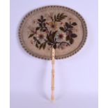 AN EARLY 19TH CENTURY CARVED IVORY EMBROIDERED FAN decorated with foliage and vines. 34 cm x 24 cm.