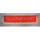 A LATE 19TH CENTURY CHINESE RED EMBROIDERED SILK BANNER decorated with a banding of foliage and