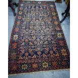 AN ANTIQUE BLUE GROUND PERSIAN HERATI RUG, decorated with symbols and motifs. 201 cm x 102 cm.
