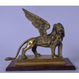 AN UNSUAL ANTIQUE HEAVY BRASS SCULPTURE OF A WINGED LION, modelled in imposing stance with one paw