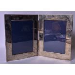 A PAIR OF SILVER PHOTOGRAPH FRAMES, unmarked. Total 23 cm x 37 cm.