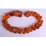 AN EARLY 20TH CENTURY CHINESE TIBETAN AMBER NECKLACE. 80 grams. 80 cm long overall.