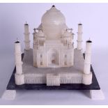 A LARGE INDIAN CARVED ALABASTER FIGURE OF THE TAJ MAHAL inset with a central gem stone, upon a black