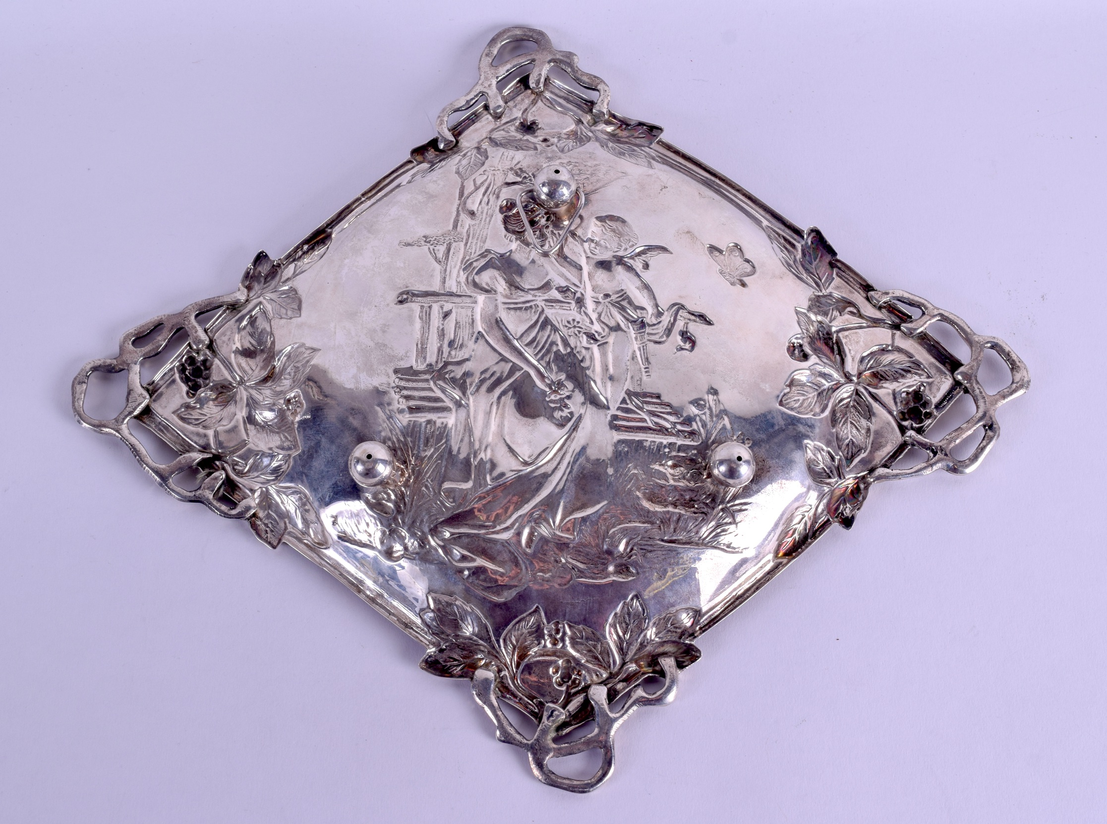 AN ART NOUVEAU CONTINENTAL SILVER LOZENGE SHAPED DISH decorated with figures seated upon a bench. - Image 2 of 3