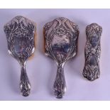 AN ART NOUVEAU THREE PIECE SILVER DRESSING TABLE SET. Sheffield 1907. Largest 24 cm long. (3)