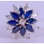 AN 18CT WHITE GOLD DIAMOND AND SAPPHIRE FLOWER RING. Size J. 5.9 grams.