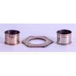 TWO SILVER NAPKIN RINGS together with a silver top. 2.6 oz. (3)