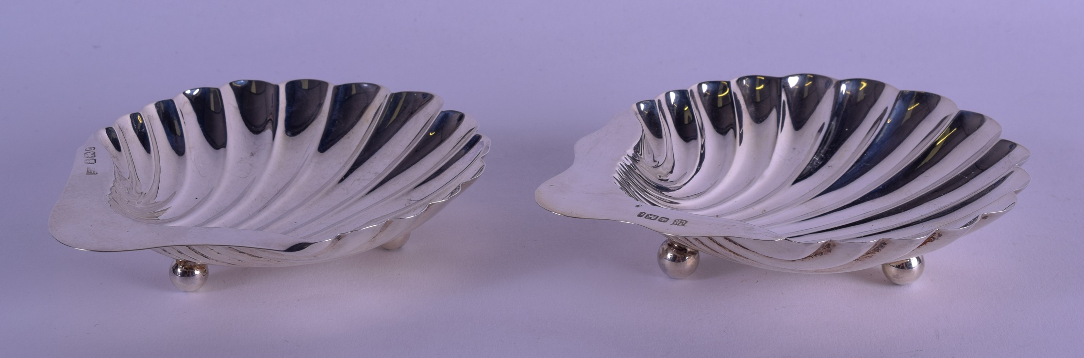 A PAIR OF SILVER SHELL SHAPED BON BON DISHES. Sheffield 1926 & 1934. 4.1 oz. 12 cm x 10 cm.