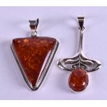 TWO SILVER AND AMBER PENDANTS. (2)