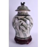 A CHINESE STUDIO POTTERY VASE AND COVER painted with floral sprays. 24 cm high.