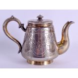 A 19TH CENTURY RUSSIAN SILVER GILT TEAPOT AND COVER decorated with extensive foliage and vines. 11.7