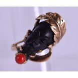 A GOOD 18CT GOLD AND CORAL BLACKAMOOR RING in the form of a female head. 5.7 grams. Size M/N.