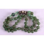 A 1920 CHINESE SILVER AND JADE BRACELET. Each strand 18 cm long.