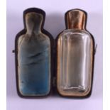 AN 18CT GOLD TOPPED SCENT BOTTLE within a fitted leather case. 9 cm high.