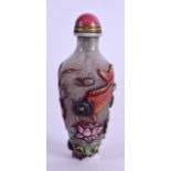 A CHINESE PEKING ENAMELLED SNUFF BOTTLE AND STOPPER bearing Qianlong marks to base, carved with