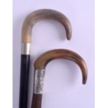 TWO LATE VICTORIAN CARVED HORN HANDLED WALKING CANES probably Rhinoceros horn, one with silver