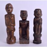 THREE UNUSUAL AFRICAN TRIBAL CARVED WOOD FIGURES. Largest 16 cm high. (3)