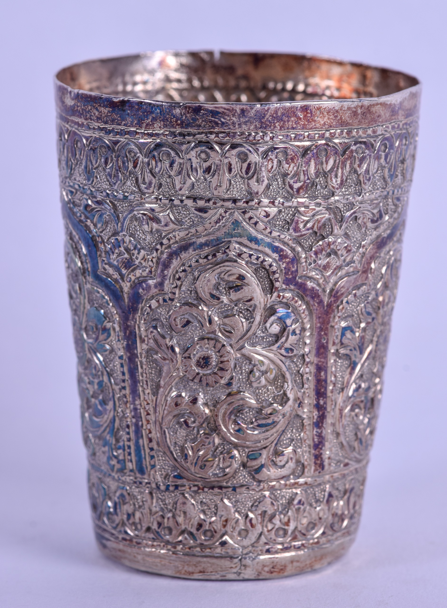 A LATE 19TH CENTURY INDIAN SILVER BEAKER decorated with foliage and vines. 2.4 oz. 6.75 cm high.