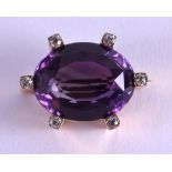 A 15CT GOLD DIAMOND AND AMETHYST BROOCH. 2.75 cm x 2 cm.