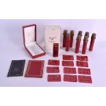 A BOXED CARTIER RED ENAMEL LIGHTER with spare flints. Lighter 6.75 cm high. (qty)