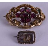 AN EARLY VICTORIAN YELLOW METAL MOURNING BROOCH together with an antique amethyst brooch. (2)