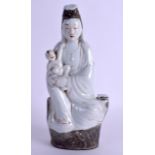AN EARLY 20TH CENTURY CHINESE PORCELAIN FIGURE OF GUANYIN modelled holding a child. 28 cm high.