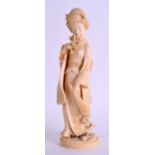 A 19TH CENTURY JAPANESE MEIJI PERIOD CARVED IVORY OKIMONO modelled as a female geisha holding