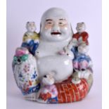 AN EARLY 20TH CENTURY CHINESE FAMILLE ROSE PORCELAIN FIGURE OF A BUDDHA modelled with five