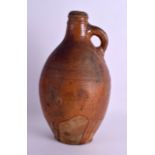 A LARGE 17TH/18TH CENTURY BELLARMINE STONEWARE JUG of plain form with short loop handle. 30 cm x