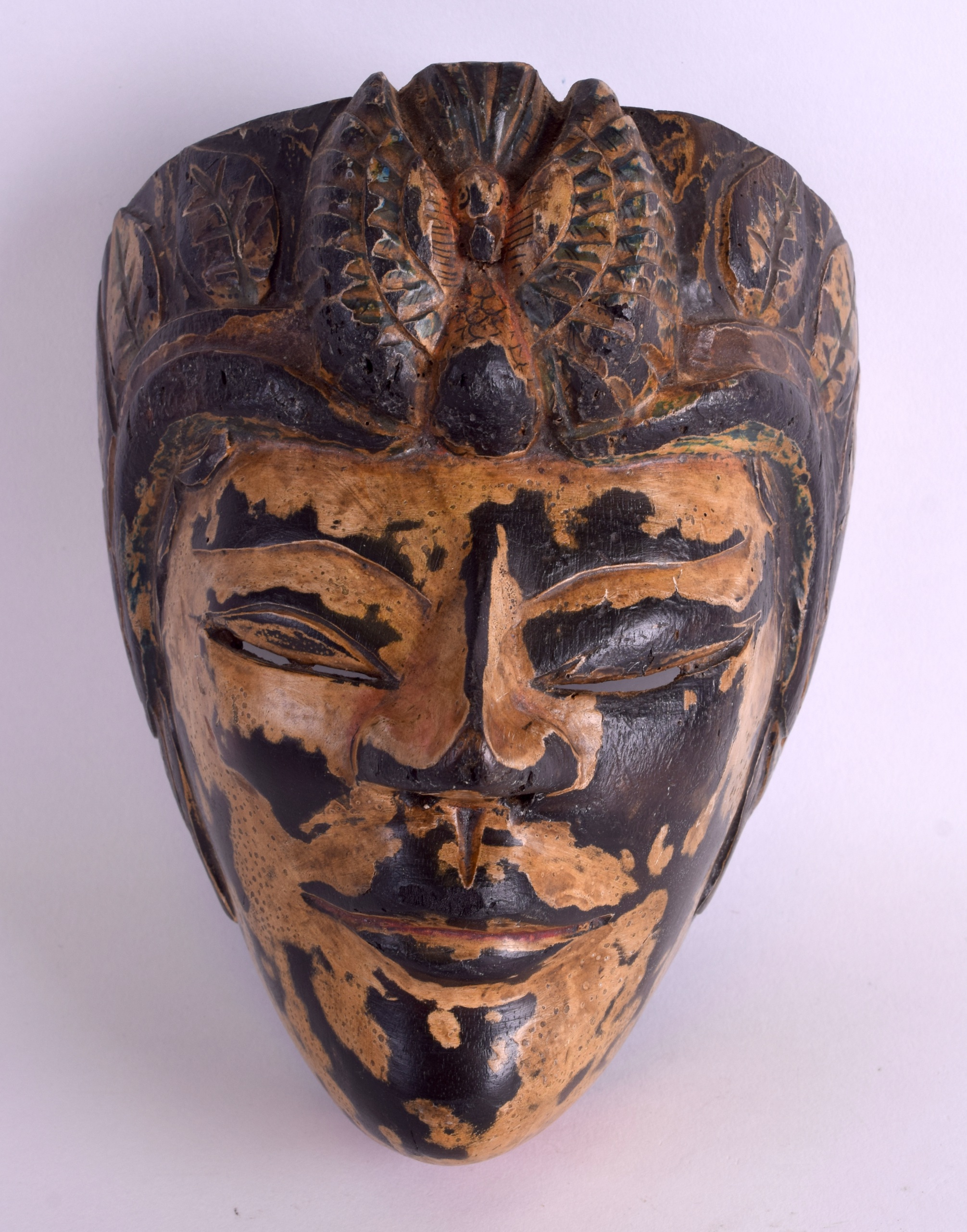 A FINE 18TH/19TH CENTURY SOUTH EAST ASIAN POLYCHROMED MASK unusually well modelled with carved