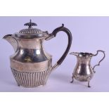 A SILVER COFFEE POT together with a classical silver cream jug. 12.6 oz. 17 cm & 7 cm high. (2)