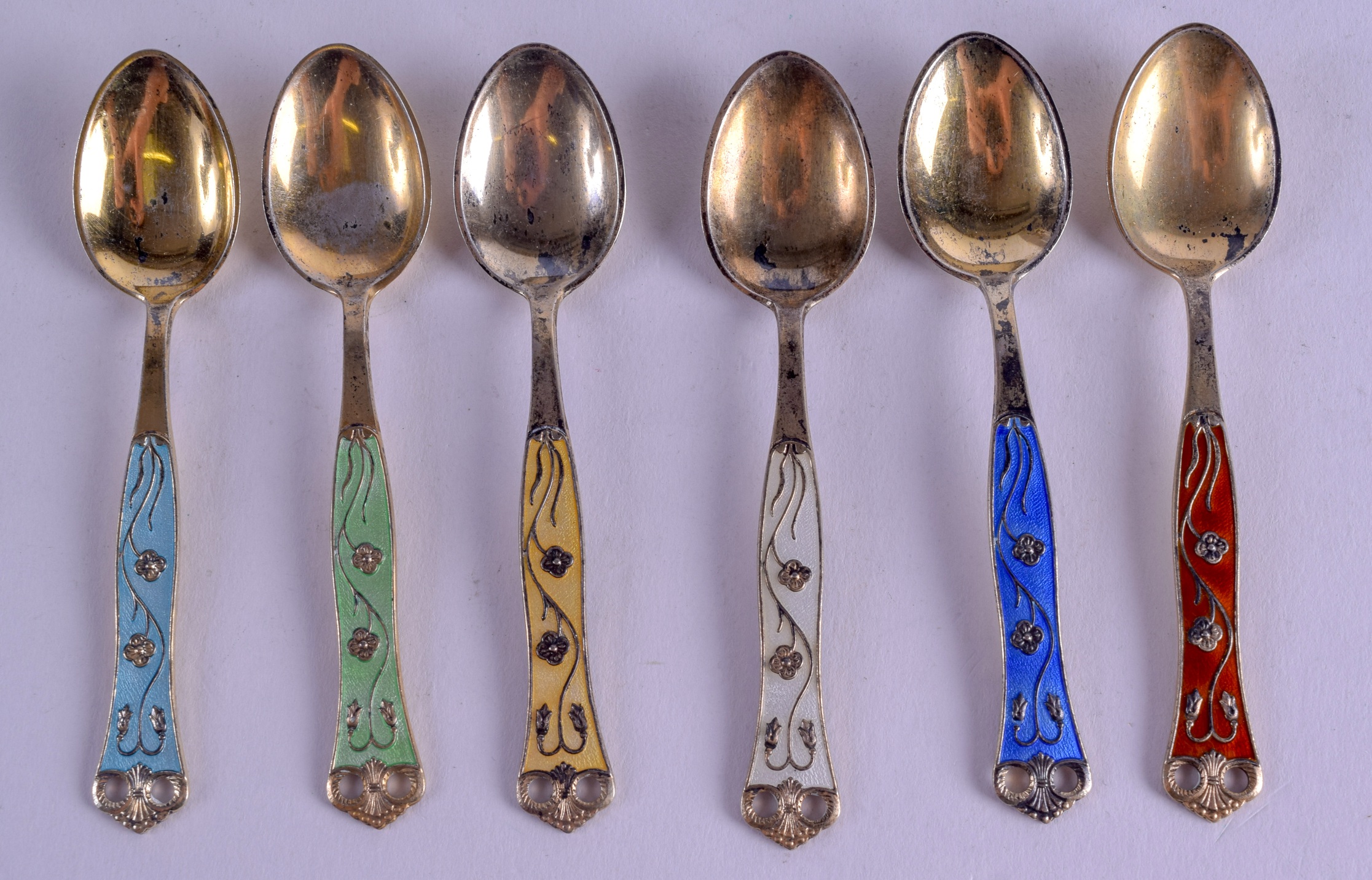 A SET OF NORWEGIAN SILVER AND ENAMEL SPOONS. 8.5 cm long. (6)