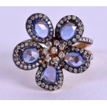 A FANCY YELLOW METAL DIAMOND AND TANZANITE RING. Size N.