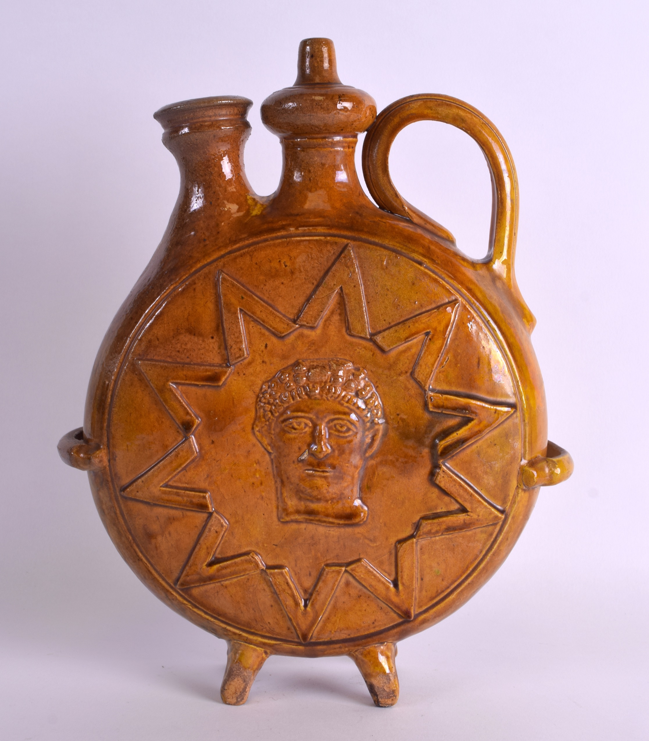 A LARGE 19TH CENTURY CONTINENTAL YELLOW GLAZED POTTERY EWER decorated with a Roman mask head