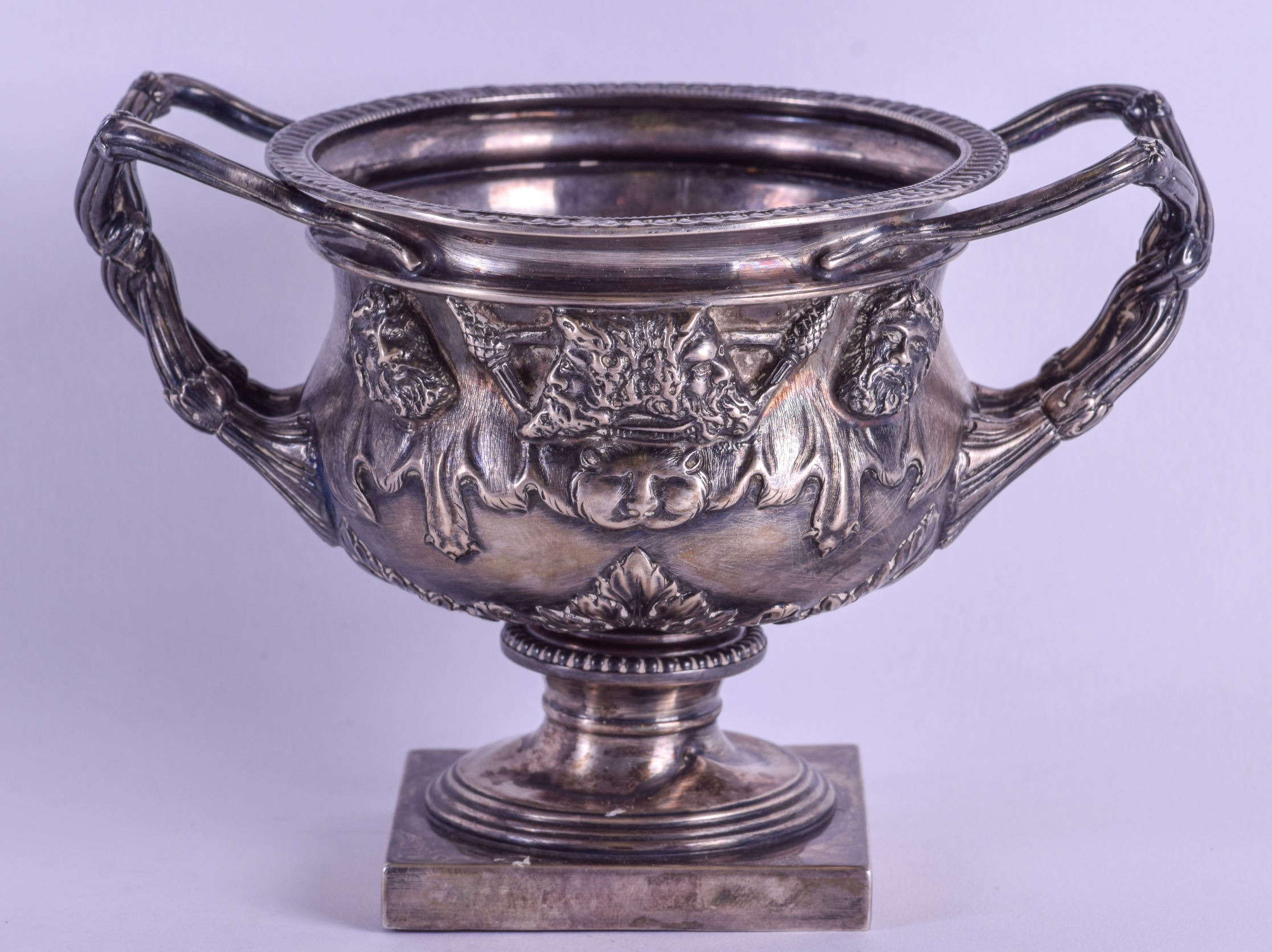 AN ENGLISH SILVER TWIN HANDLED WARWICK VASE decorated with classical figures upon a pedestal base. - Image 2 of 3