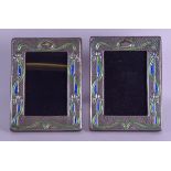 A PAIR OF ART NOUVEAU STYLE SILVER AND ENAMEL PHOTOGRAPH FRAMES decorated with foliage and vines. 14