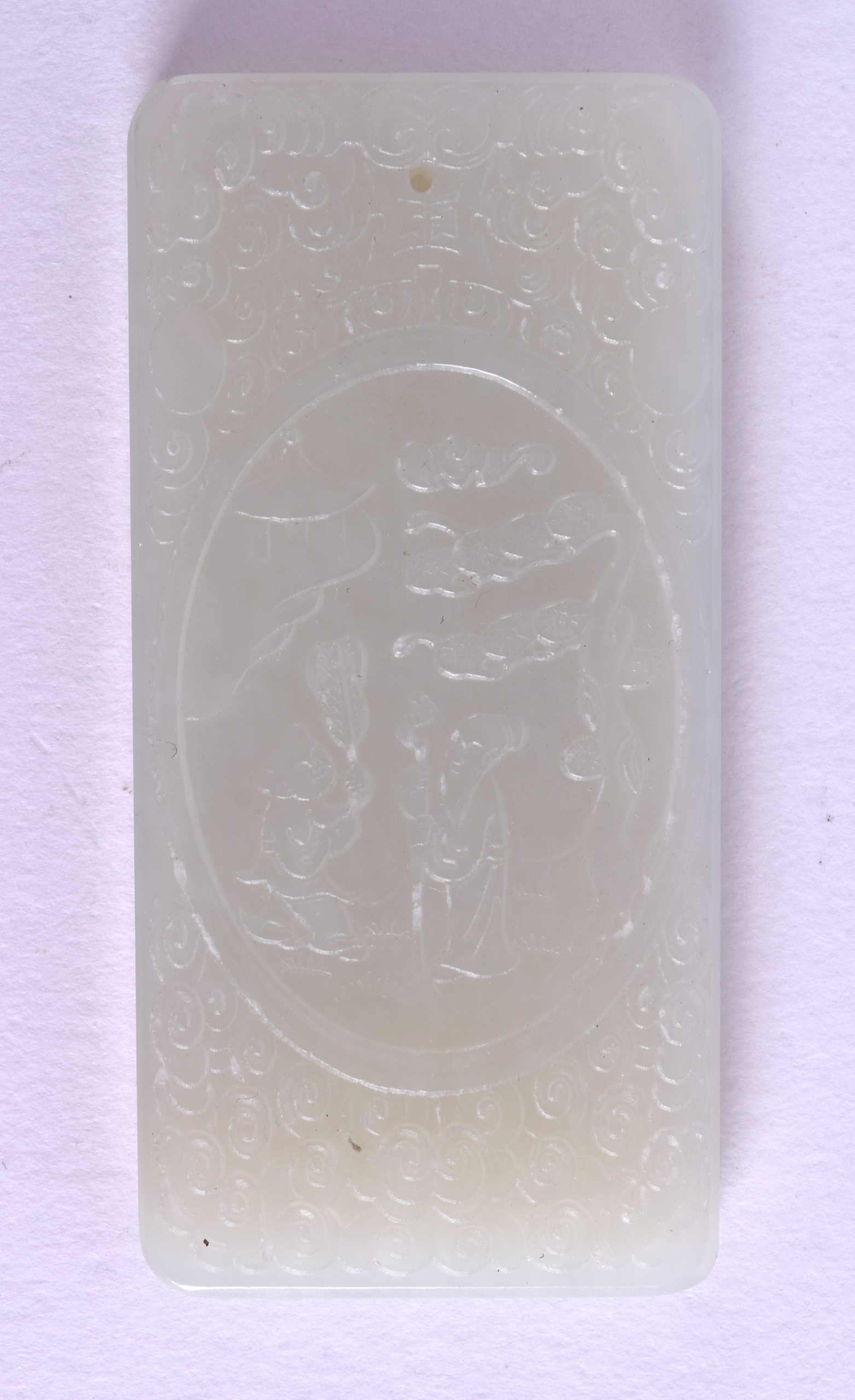 A SMALL CHINESE CARVED GREENISH WHITE JADE TABLET Late Qing, decorated with figures. 3 cm x 6.25